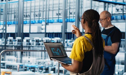 Engineering team working in smart factory, collecting and analyzing data. Teamworking colleagues using tracking software in industry 4.0 industrial plant equipped with advanced sensors, camera A